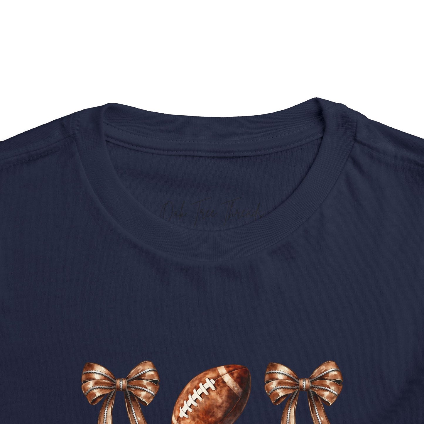 Toddler Tee — Footballs & Bows Pattern (BELLA +CANVAS)