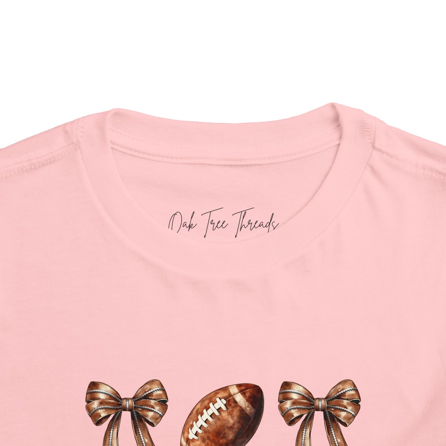 Toddler Tee — Footballs & Bows Pattern (BELLA +CANVAS)