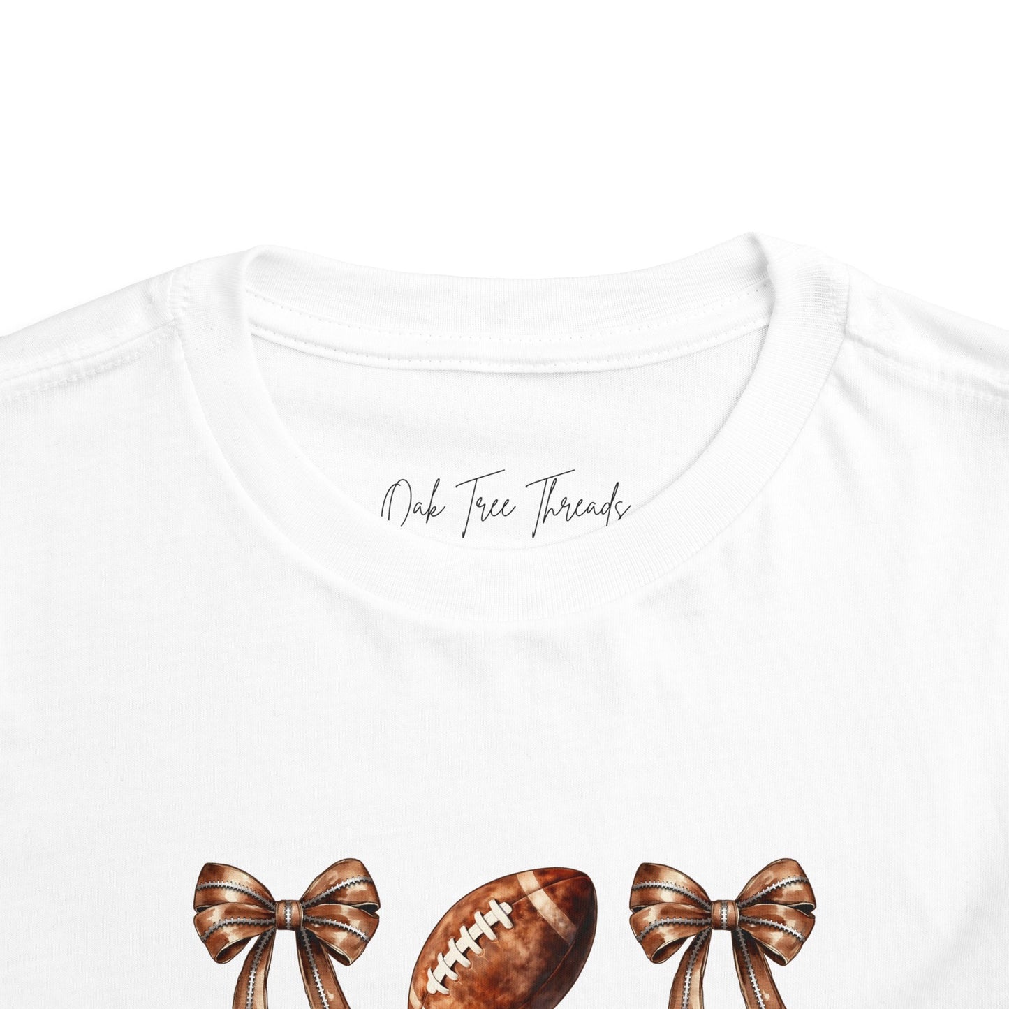 Toddler Tee — Footballs & Bows Pattern (BELLA +CANVAS)
