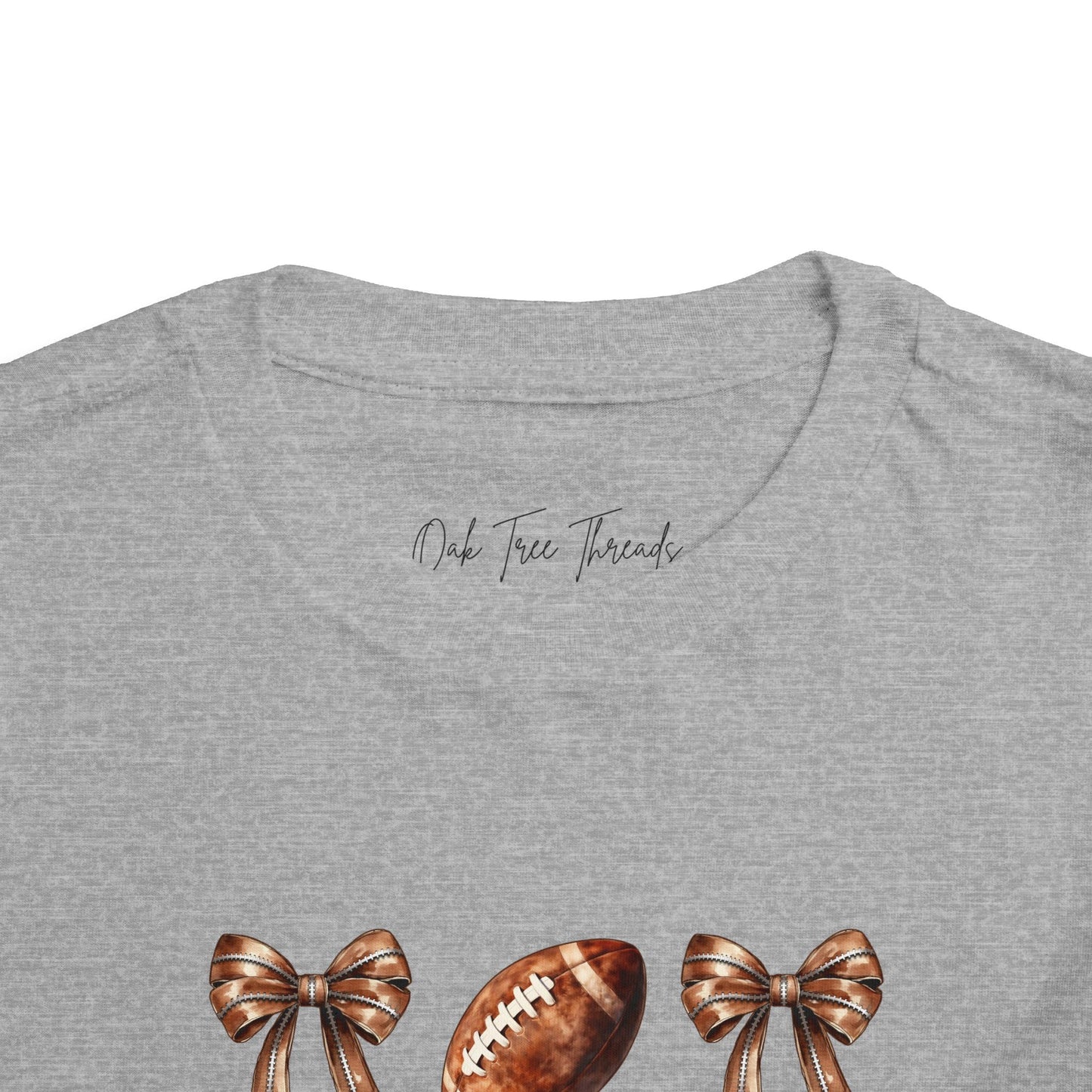 Toddler Tee — Footballs & Bows Pattern (BELLA +CANVAS)